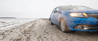 Gomel, Belarus - February 21, 2017: Car Renault - Logan in the winter forest with headlights